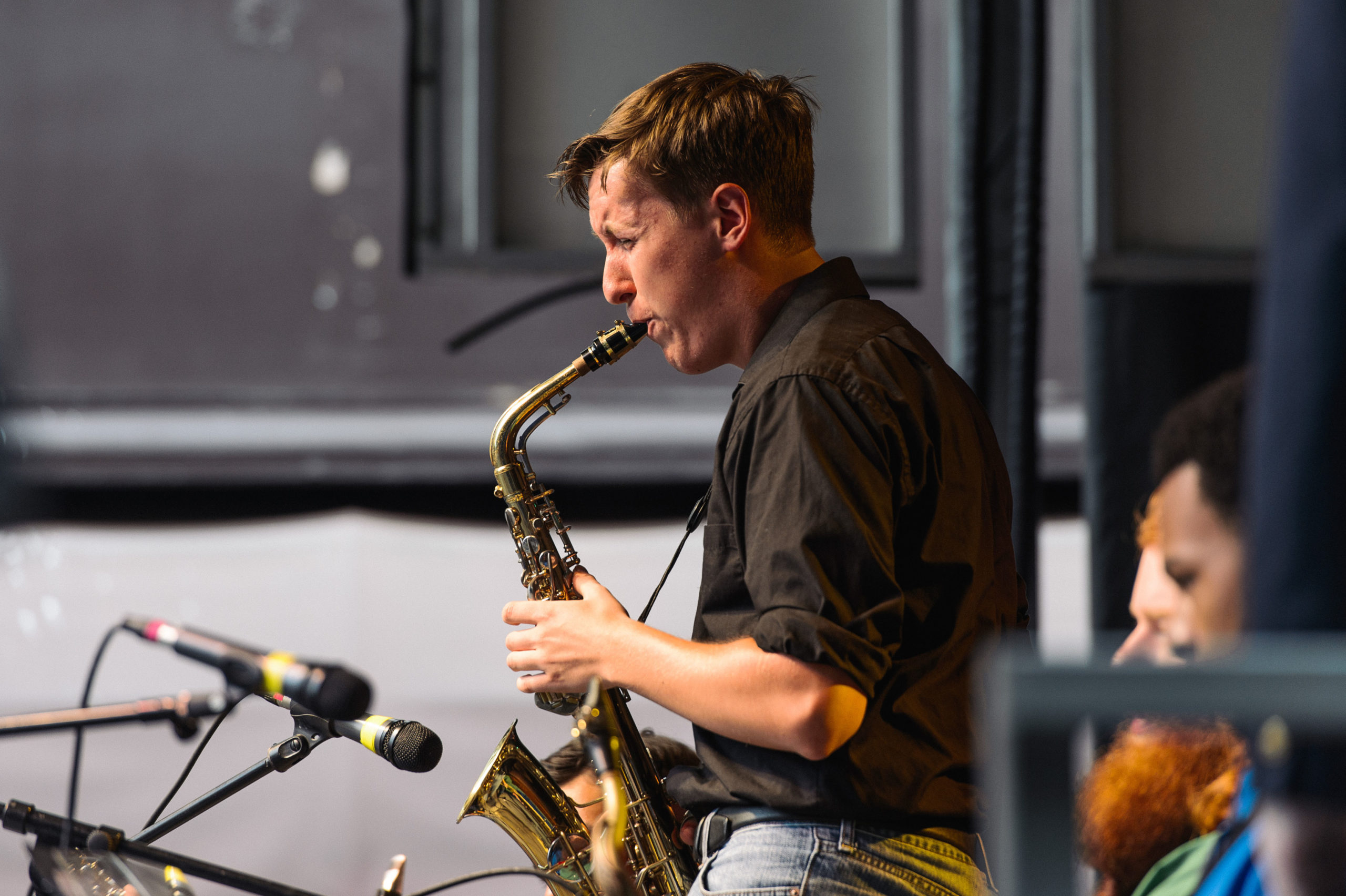 In this photo, Eastman Youth Jazz Orchestra, and New Horizons Vintage Jazz Band, and Music Educators Big Band, play on the Jazz Street Stage during the Xerox Rochester International Jazz Festival, Gibbs Street, Rochester, NY. The music performance was presented by The Community Foundation. Photo by Brandon Vick, University Communications http://www.rochester.edu