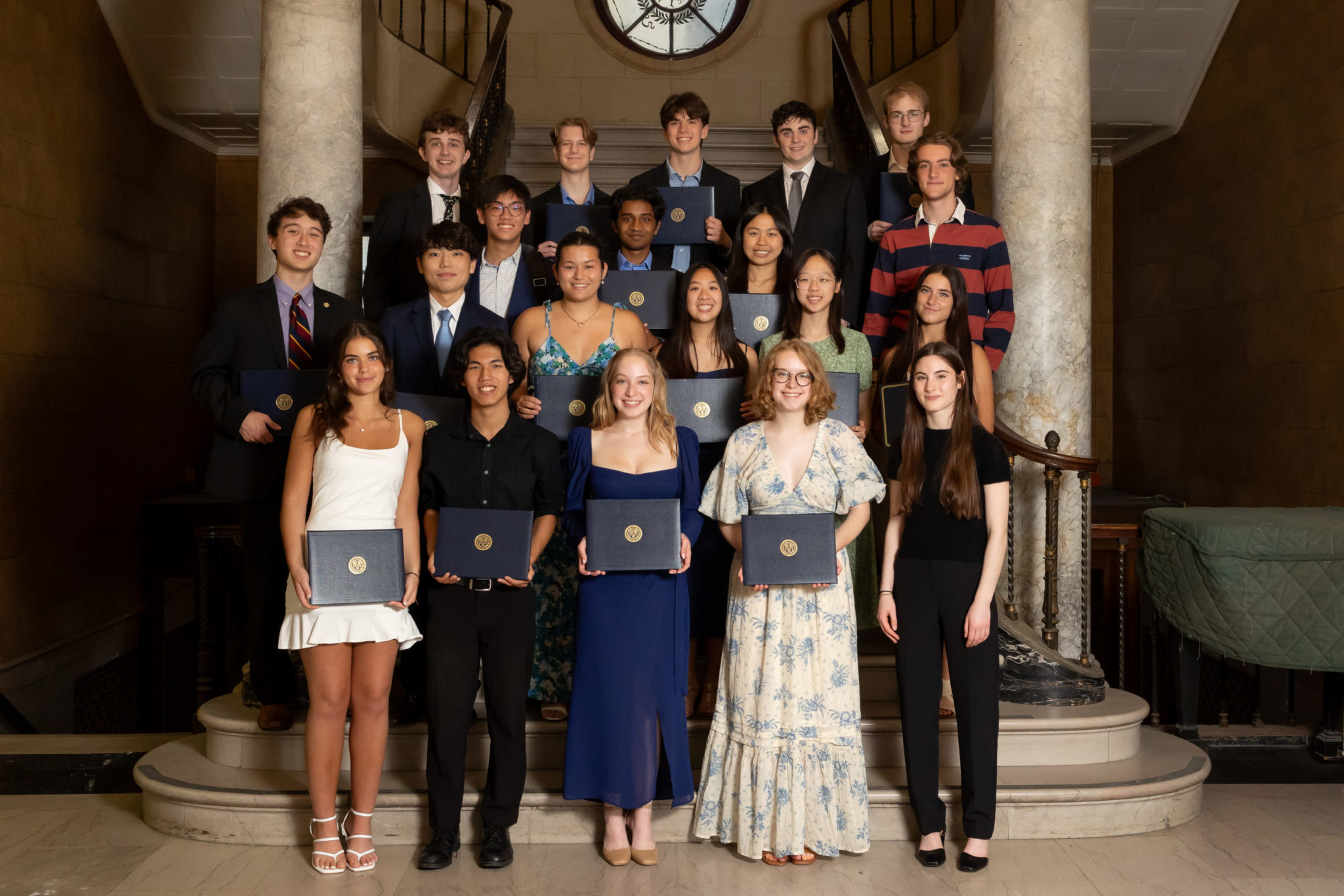 Eastman Community Music School Students holding their diplomas on the steps of Lowry Hall