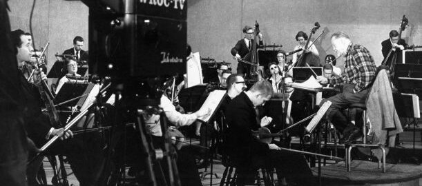 Howard Hanson conducts the Eastman Philharmonia on the WROC-TV studio stage, with a WROC-TV camera in the foreground.