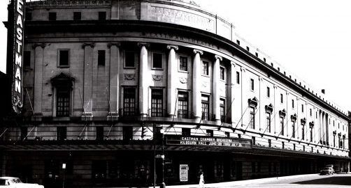 Eastman Theatre exterior (1940s-1950s) Black and white photo of the exterior of Eastman Theatre, viewed from the northwest corner of Main Street and Gibbs Street (circa 1940 to 1950s).
