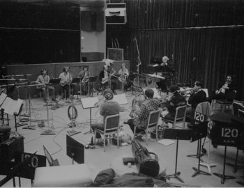 Rayburn Wright, Eastman Jazz Ensemble director, conducting members of the Eastman Jazz Ensemble in Room 120 (today known as the Ray Wright Room) on February 27th, 1983 during the recording session for the French-Canadian film Bonheur d’occasion. Louis Ouzer Archive