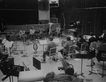 Rayburn Wright, Eastman Jazz Ensemble director, conducting members of the Eastman Jazz Ensemble in Room 120 (today known as the Ray Wright Room) on February 27th, 1983 during the recording session for the French-Canadian film Bonheur d’occasion. Louis Ouzer Archive