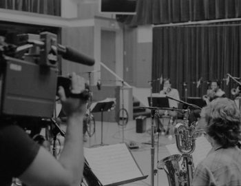 A cameraman for local television news captures footage of the Eastman Jazz Ensemble’s recording session on February 27th, 1983. Louis Ouzer Archive