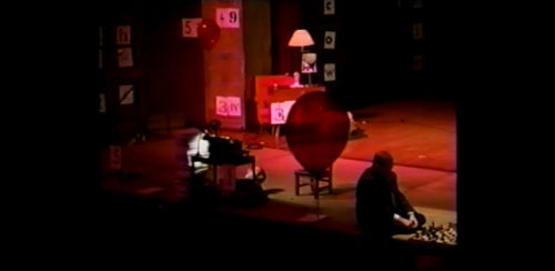 Part I at 29-08 having moved the chair aside, performer begins to lower himself