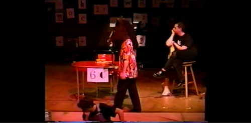 Part I at 30-34 performer returning wearing animal head
