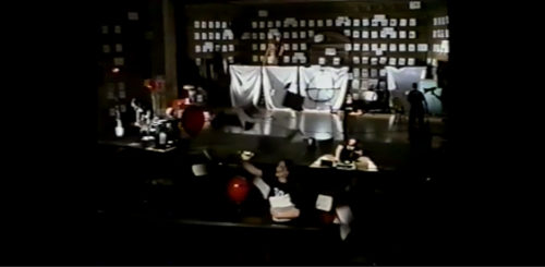 Part I at 44-00 more than one performer has gone into the house and is strewing sheets of paper all about