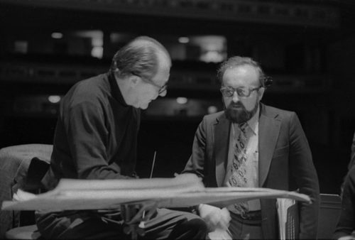 R1393-23 Conductor Walter Hendl, composer Krystof Penderecki, and soloist Felicja Blumental conferring over the score in the Eastman Theater. Ms. Blumental’s husband Markus Mizne is seen in the background in several of these shots.