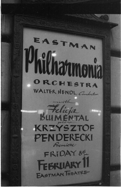 R1397-15 Eastman Philharmonia concert that featured the premiere of Krzystof Penderecki’s Partita for Harpsichord and Orchestra. At the conclusion of the Partita, Maestro Hendl invites the composer to the stage for bows. In the last shot, the composer, the soloist, and the conductor all join hands to acknowledge the applause.