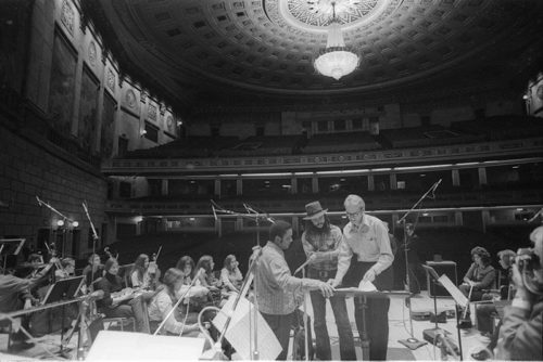 Oliver Nelson, Chuck Mangione, and Ray Wright confer on the podium in the Eastman Theater preparatory to the Eastman Jazz Ensemble and Eastman Studio Orchestra joint concert of March 3rd, 1972