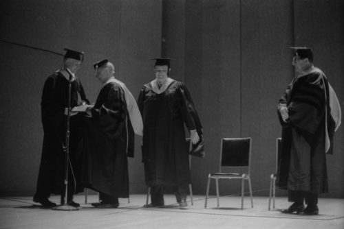 Conferral of the honorary Doctor of Music degree on guest artist Rudolf Serkin. UR President W. Allen Wallis presides; Director Walter Hendl presents the degree and reads the citation; and Assistant Director Daniel R. Patrylak hoods the newly designated Dr. Serkin.