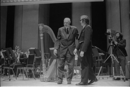 R1486-33A Howard Hanson greets Donald Hunsberger and acknowledges the audience’s applause on the occasion of the Eastman Wind Ensemble’s premiere performance of his Dies Natalis II, April 7th, 1972.