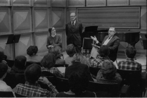 R2661-3A Mr. Schonberg speaking from the stage in Howard Hanson Hall. Professor Donald Shetler of the Music Education Department sits to his left.