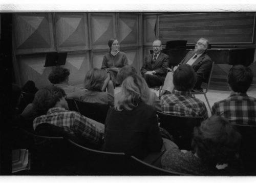 R2664-20 Mr. Schonberg speaking from the stage in Howard Hanson Hall. Professor Donald Shetler of the Music Education Department sits to his left.