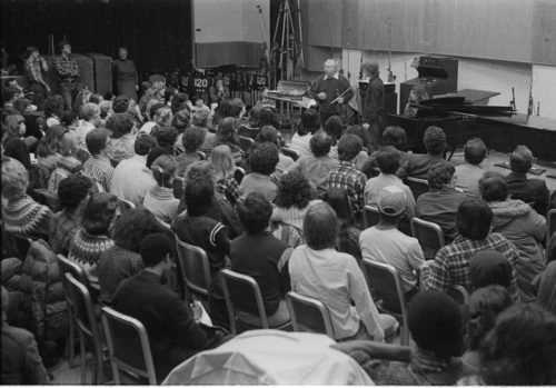 Violinist Isaac Stern working with an Eastman violin student during a master class in Room 120