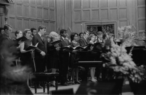 R583-13A Members of the Eastman Chorale on-stage in Kilbourn Hall, conducted by Professor Milford Fargo. In the first two shots, baritone Joseph Bias (not holding a score) is the soloist.