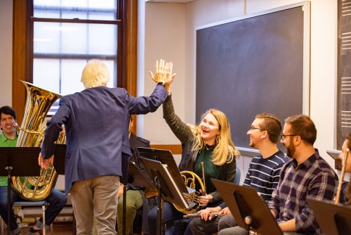 Chris Azzara high fives a student Chris Azzara high fives a student