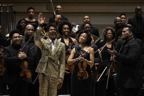 Musicians in the 2022 Gateways Music Festival Orchestra Concert perform with conductor Anthony Parnther and pianist Jon Batiste