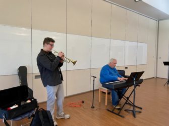 Jazz major Wesley Benjamin plays an impromptu Autumn Leaves with concert attendee, Eugene. Photo credit: Sylvie Beaudette