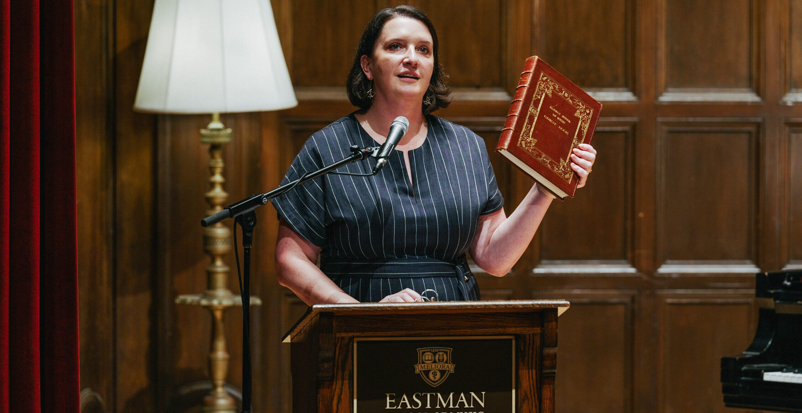 Dean Sheeran holds up Eastman’s famed guestbook