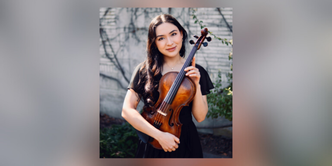 woman in black dress, standing outside, holding a viola