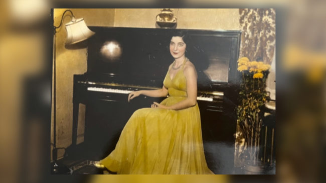 Alumna Gloria Mikialian '45E in a yellow dress at the piano. Date unknown.