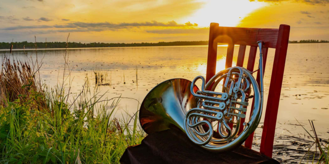 Image of horn on chair with sunset over water behind