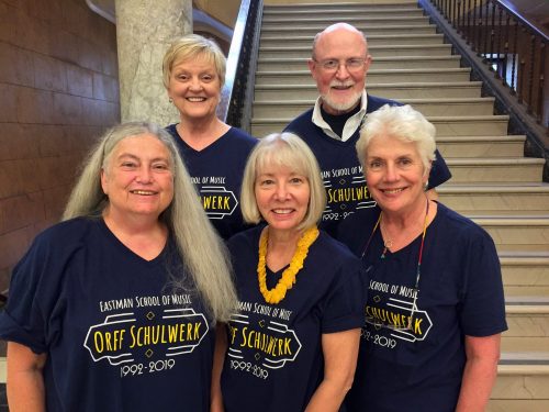 Karen Medley, program director Donna Brink Fox, Mary Helen Solomon, James Solomon, Janet Robbins Five faculty members in dark blue T-shirts standing on staircase in Lowry Hall.