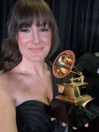 Associate Professor of Jazz Voice Sara Gazarek holds a GRAMMY trophy 