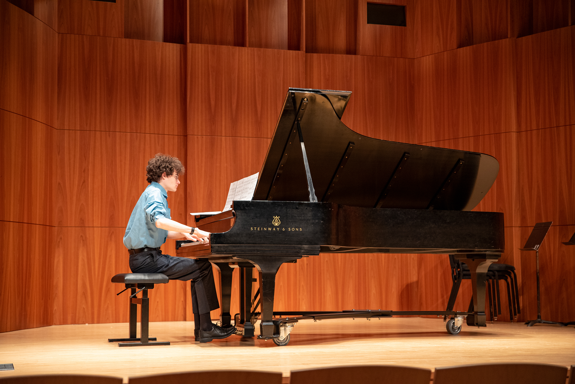 Student playing piano in Hatch Hall Student playing piano in Hatch Hall image