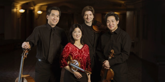 Ying Quartet stand with instruments in Eastman Theatre lobby
