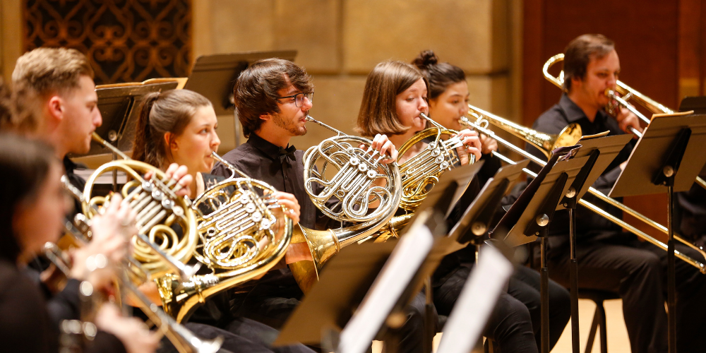 multicrop_brass weekend article 2024 Brass Guild in Eastman Theatre, showing from left to right: trumpets, French horns, and trombones. Photo by Matt Wittmeyer.